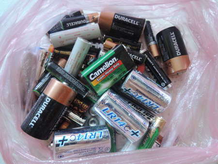 Many used AA and AAA sized batteries in a pile.のeditorial素材