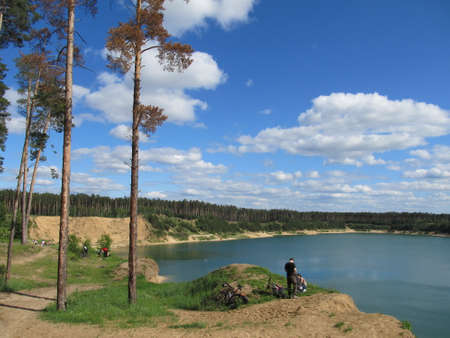 beautiful lake where tourists came to have a picnic, someone rides a mountain bikeのeditorial素材