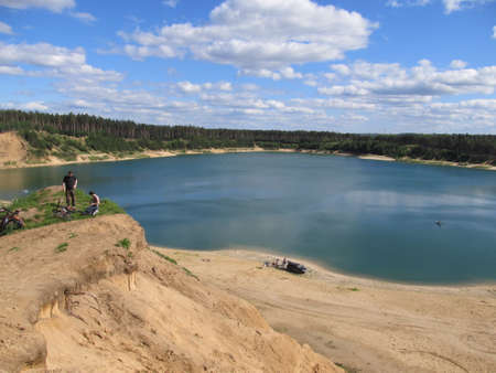 beautiful lake where tourists came to have a picnic, someone rides a mountain bikeのeditorial素材