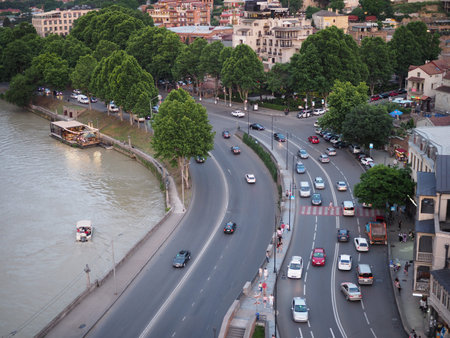 Aerial evening view of Old Tbilisi, Georgia with illuminated buildings and car traffic. Georgia,...