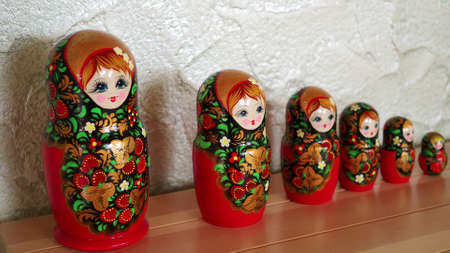 Matryoshka-Russian folding doll made of wood, inside which there are dolls of smaller size. Semenovskaya matryoshka is painted bright, with black hair, a handkerchief on her head.のeditorial素材