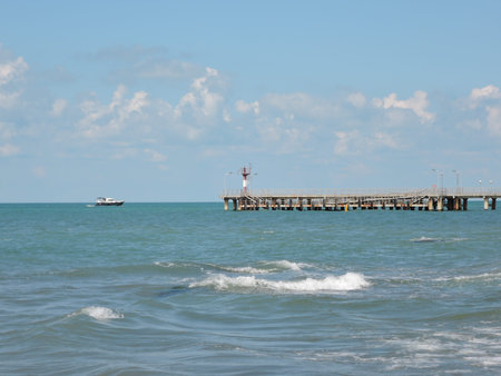 summer landscape with sea, a pier and a boat