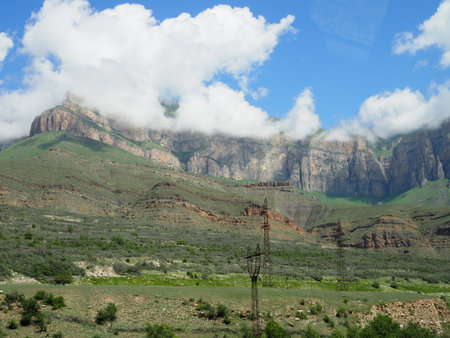 beautiful mountain landscape with a river flowing across the plain on a Sunny summer dayの写真素材