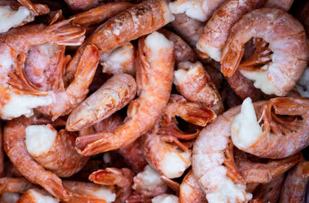 Close-up of a pile of large frozen red shrimps. Natural bright seafood background.の写真素材