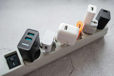 Running modern extension power strip with many different USB DC output ports. Cracked concrete background. Copy space.の写真素材