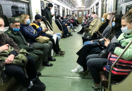 Moscow, Russia, October 2020: Passengers in protective masks in a subway car. The rules of the city during a pandemic.のeditorial素材