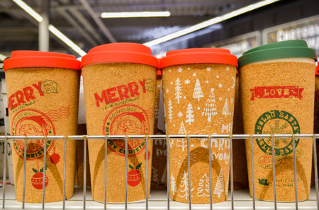 Moscow, Russia, October 2019: Reusable takeaway coffee mugs with cork coating and Christmas patterns. Sale at the winter fair.のeditorial素材