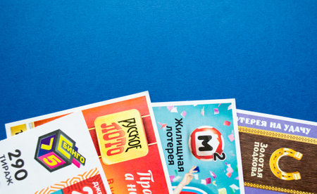 Moscow, Russia, July 2020: Various Russian lottery tickets on a blue background. Russian Lotto.のeditorial素材