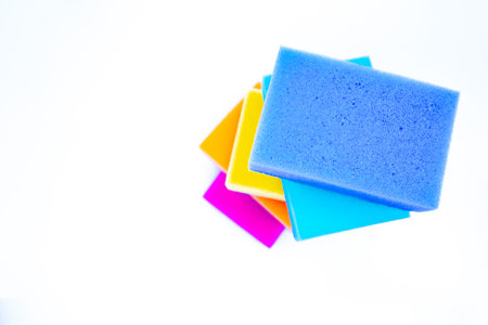 Top view of sponges for washing dishes, on a white background, isolated. Colorful multi-colored as rainbow sponges lay one each other.の写真素材