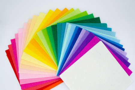 The square pieces of felt spread out by a color spectrum on similarity of a rainbow from white to red.の写真素材