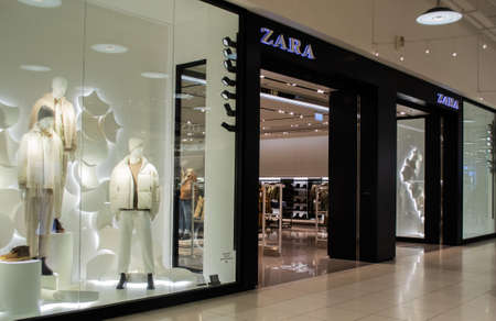 Moscow, Russia, November 2020: Entrance to the Zara store. Men Fashion department. In the window are mannequins in light-colored winter clothes.のeditorial素材