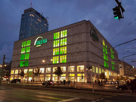 Berlin, Germany, October 2019: Galeria kaufhof Store. Evening, shop Windows and sign glow green. Behind the store building - Park Inn hotel.のeditorial素材