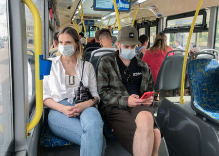 Moscow, Russia, August 2020: Passengers on a bus wearing protective medical masks.のeditorial素材