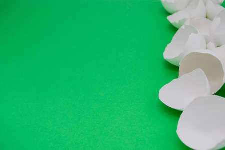 Lots of broken white eggshells on a white background. On the left. copyspace.の写真素材