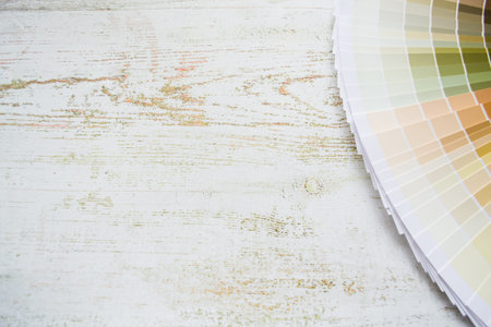 Paper Fan paint samples interior design wall painting natural Colors. Wooden background, copy space.