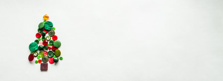 Banner with tree made of buttons of green, red color. white background, copy space. Creative Christmas Concept or gardening.の写真素材