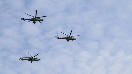 Moscow, Russia, May 2022: The flight of three Mi-24 military helicopters in the sky. The main rehearsal of military parade.のeditorial素材