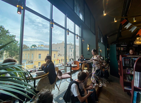 St. Petersburg, Russia, August 2021: Workspace for coworking, online study, remote work. Young women...