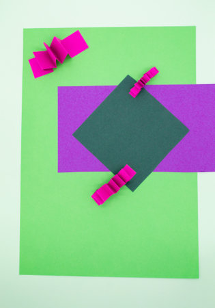 Abstract background in green, pink and purple colors with 3D paper elements, zig zag pattern. As a backdrop for advertising products, copy space.の写真素材