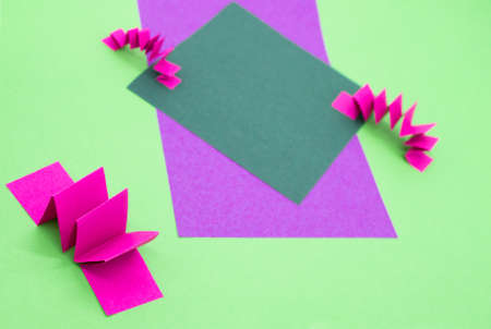 Abstract background in green, pink and purple colors with 3D paper elements, zig zag pattern. As a backdrop for advertising products, copy space.の写真素材