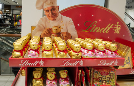 Moscow, Russia, November 2020: Lindt chocolate Teddy bears in gold foil and with a red heart pendant are sold in a supermarket.のeditorial素材