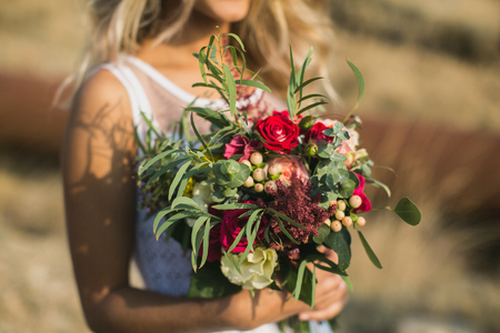 The bride in a white dress with beautiful bouquetの写真素材