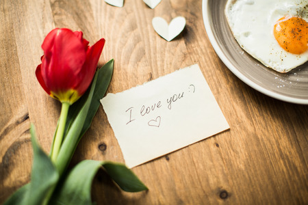 Romantic breakfast with scrambled eggs in a heart-shaped Valentine's Dayの写真素材