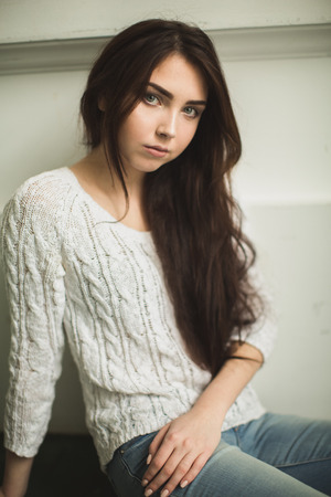 Portrait of a young lady in photostudio interiorの写真素材