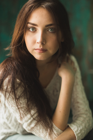 Portrait of young lady in photostudio interiorの写真素材