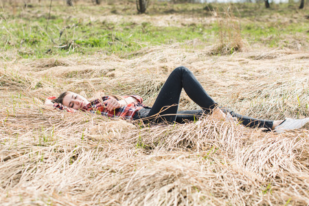 Girl in shirt lies on strawの写真素材