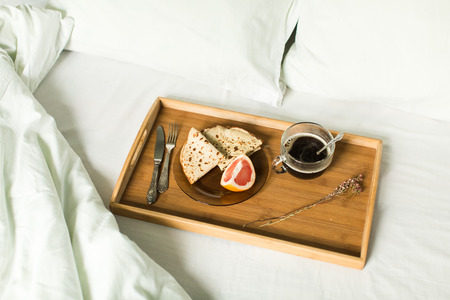 breakfast in bed , pancakes , coffee and grapefruitの写真素材