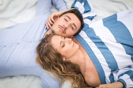 young couple man and woman lie on the rugの写真素材