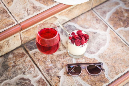 healthy breakfast : yogurt, glass of juice and fresh raspberries