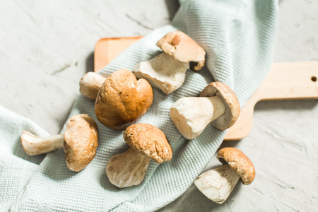 fresh white mushrooms on wooden boardの写真素材