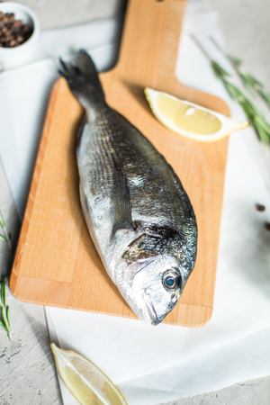 Fresh dorado fish with herbs and pepperの写真素材