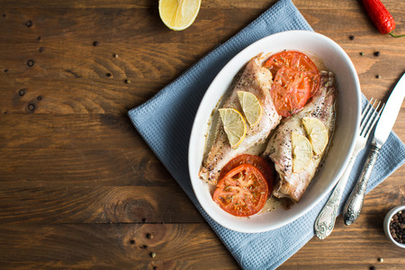 Baked sea bass with tomatoesの写真素材