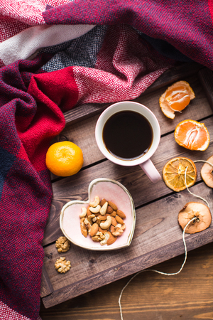 wooden tray with coffee, nuts and orangeの写真素材