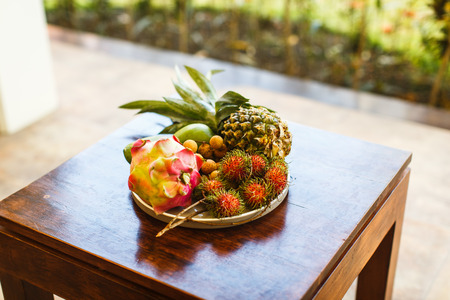 exotic fruits on plate in villa: mango, dragon fruit; mango; pineapple and rambutanの写真素材