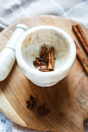 stone mortar for spices: cinnamon and star aniseの写真素材