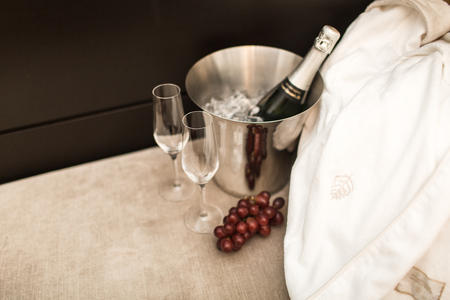 bottle of champagne and glasses in hotel roomの写真素材