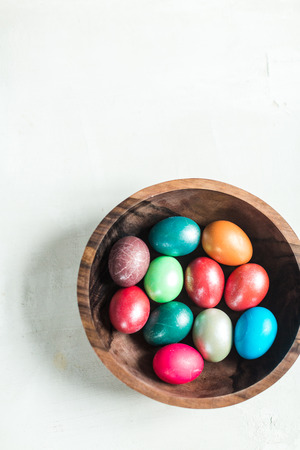 Dyed eggs in wooden plateの写真素材