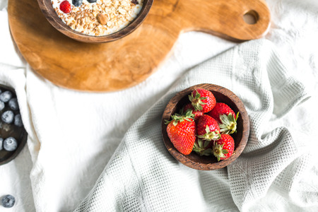 Fresh strawberries in a wooden bowlの写真素材