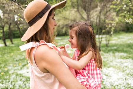 Mum is holding a small daughter in her armsの写真素材