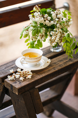 A cup of tea and a saucer on the summer verandaの写真素材