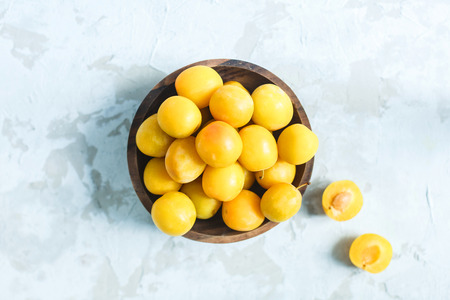Fresh yellow cherry plum in a bowl close upの写真素材