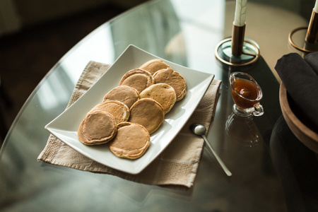 pancakes on white plate with strawberry jamの写真素材