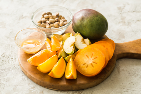assorted different fruits: persimmon, apple, orangesの写真素材