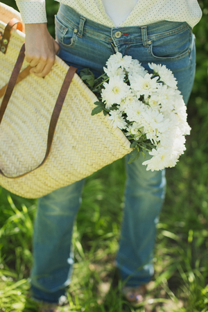 young girl with a basket of flowers chrysanthemumの写真素材