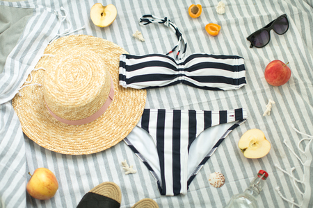 summer woman accessories on the beach, swimsuit, hat and glassesの写真素材