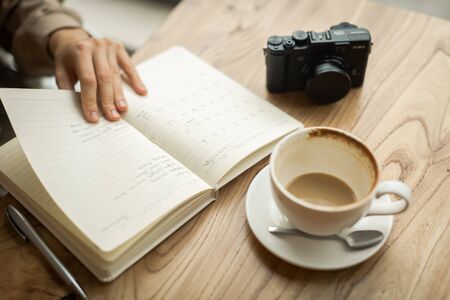 young girl in a meeting at breakfast with a notebookの写真素材